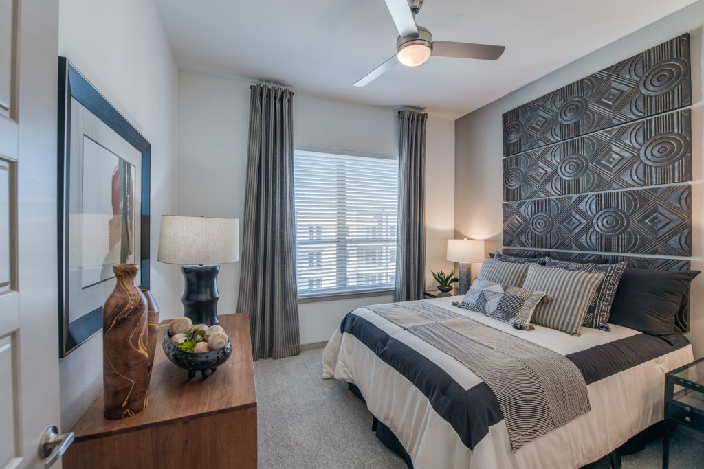 bedroom with window, carpet, ceiling fan, and decor