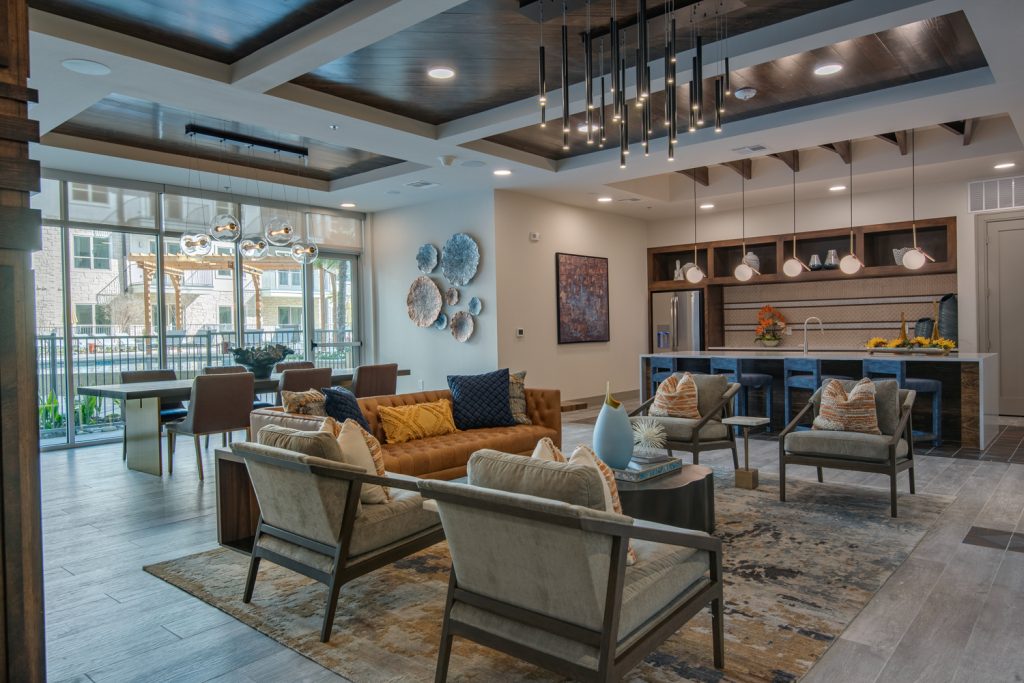 clubhouse area with lots of seating, overhead lighting, and demo kitchen