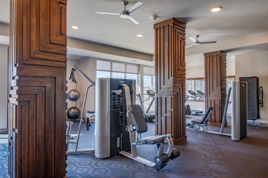 fitness center with weight machines and ceiling fans