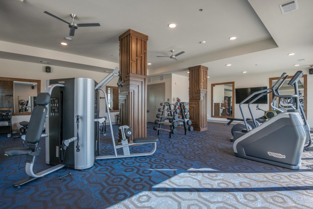 fitness center with equipment, carpet floors, and ceiling fans