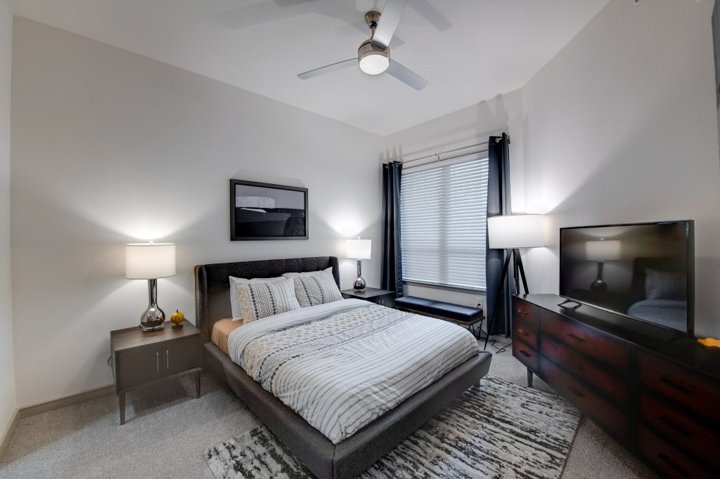 bedroom with ceiling fan and decor