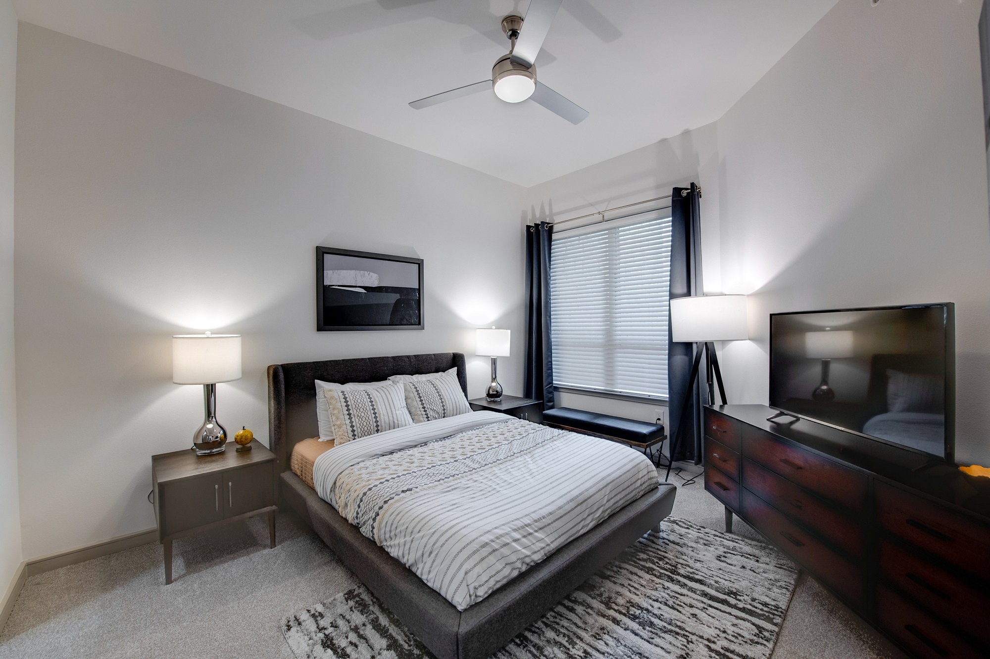 bedroom with ceiling fan and decor