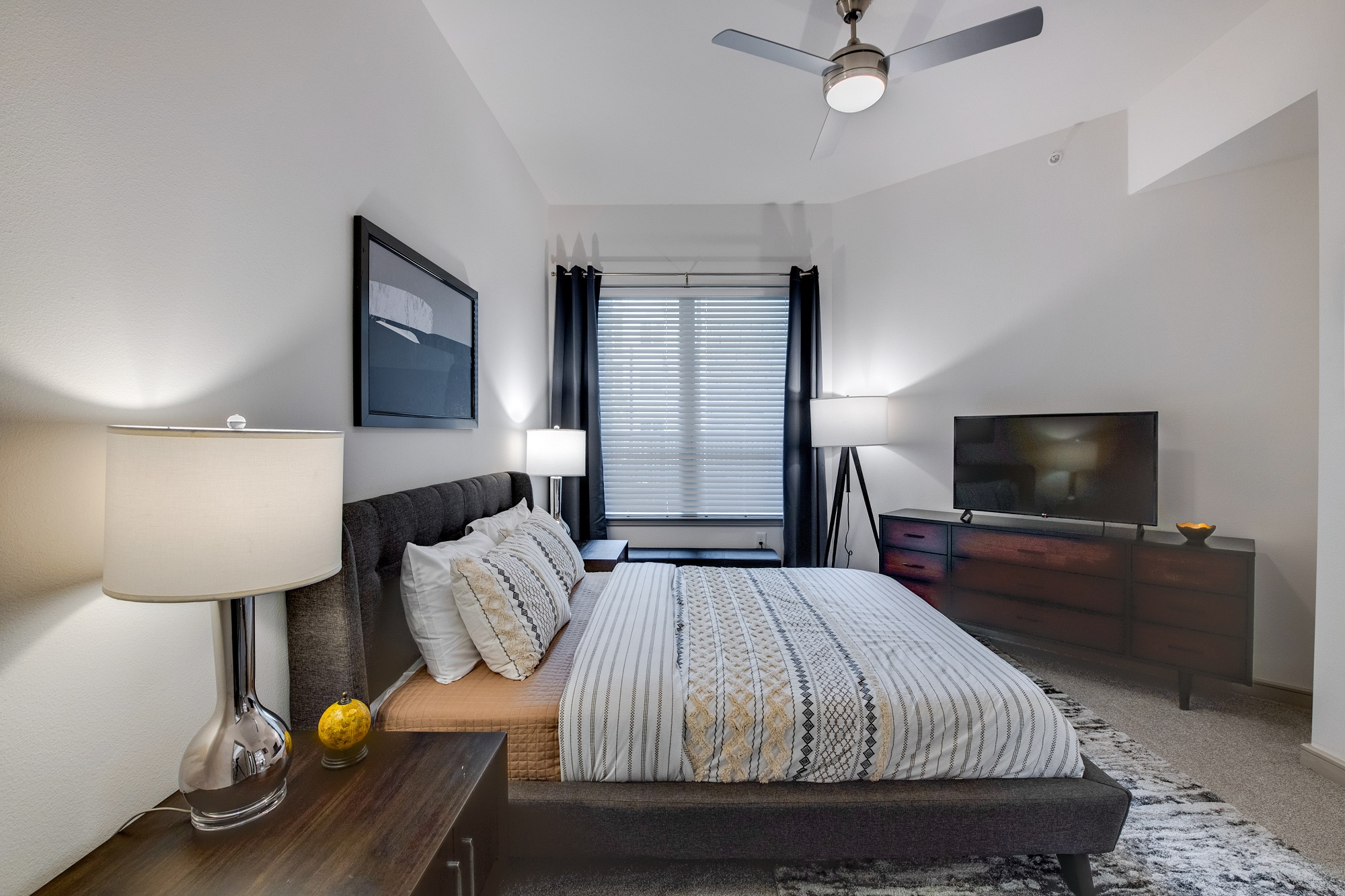 bedroom with ceiling fan and decor