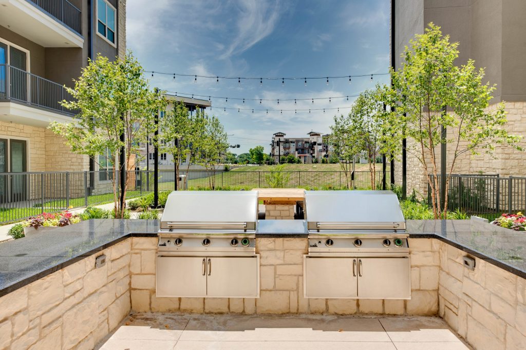 courtyard area with grills and string lights